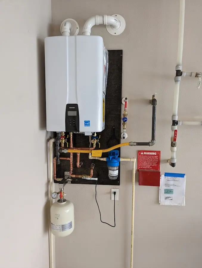 Professional plumber installing copper piping in a San Mateo home